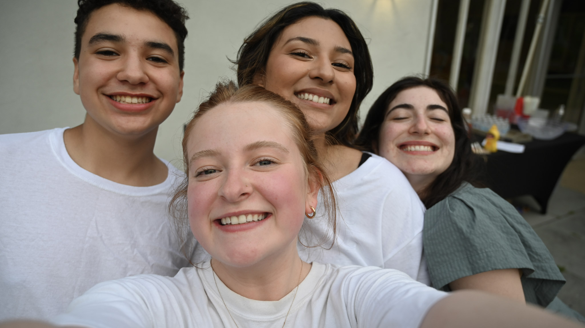 Friends smiling together for a group selfie