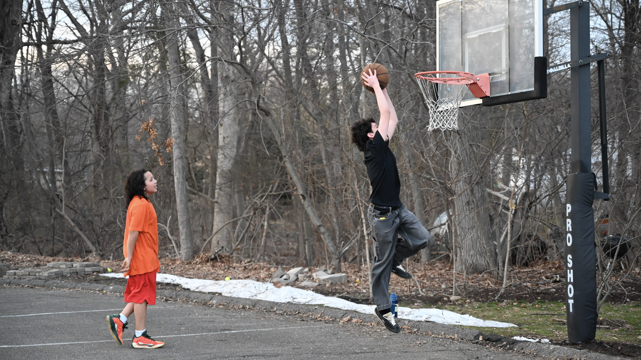 Students playing basketball outside the church