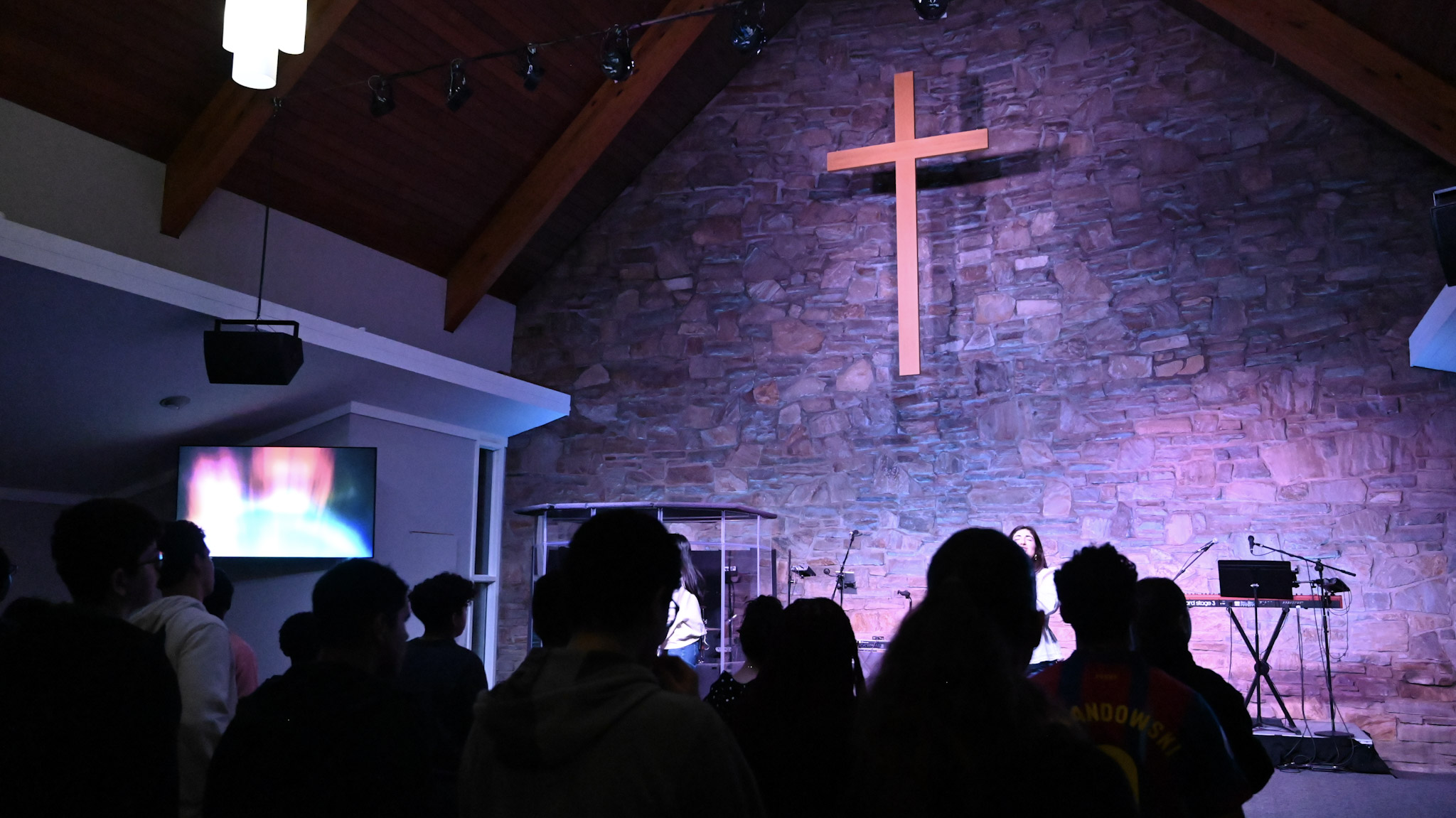 Students gathered for worship in the church sanctuary