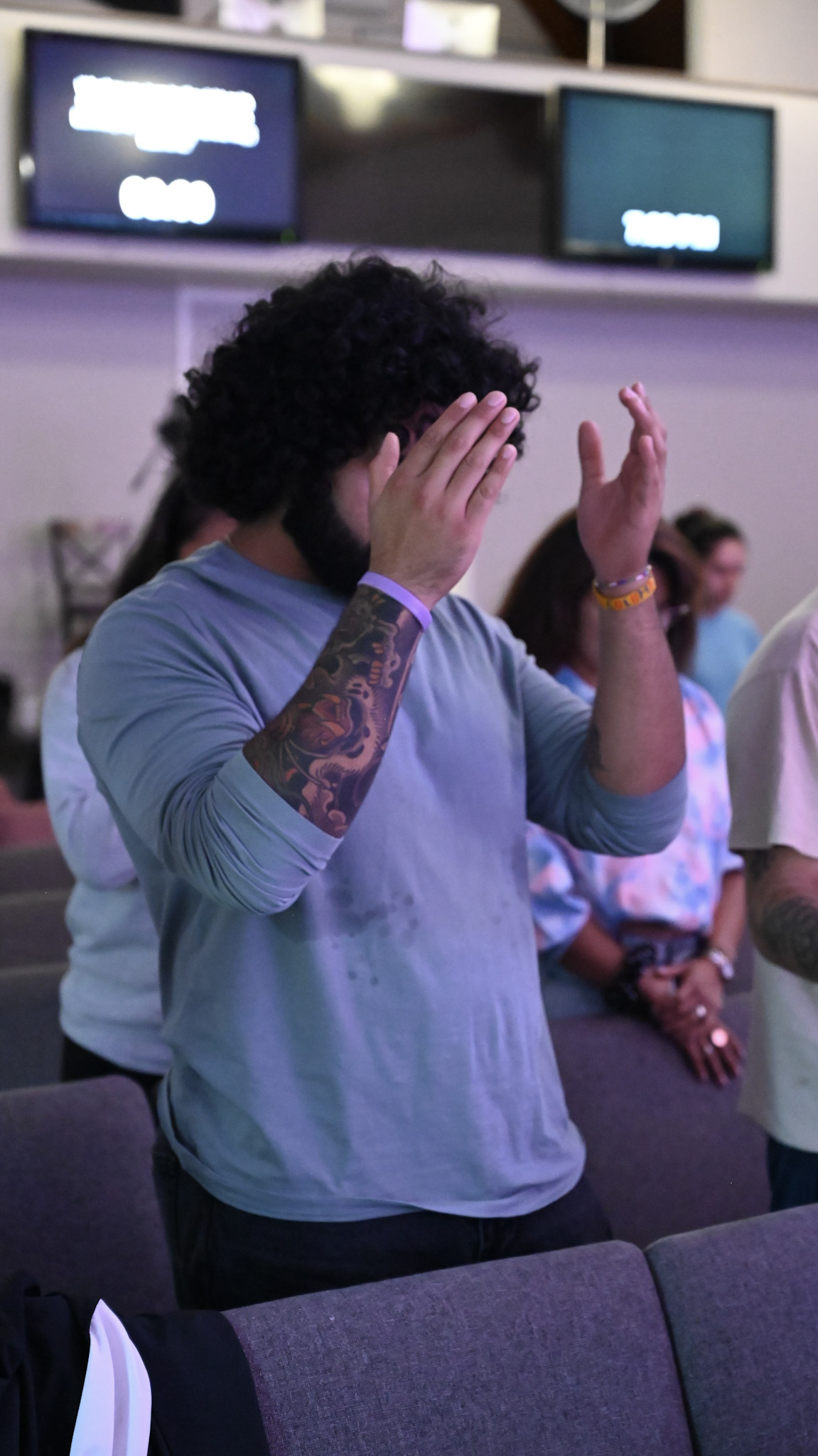 A young adult participating in worship