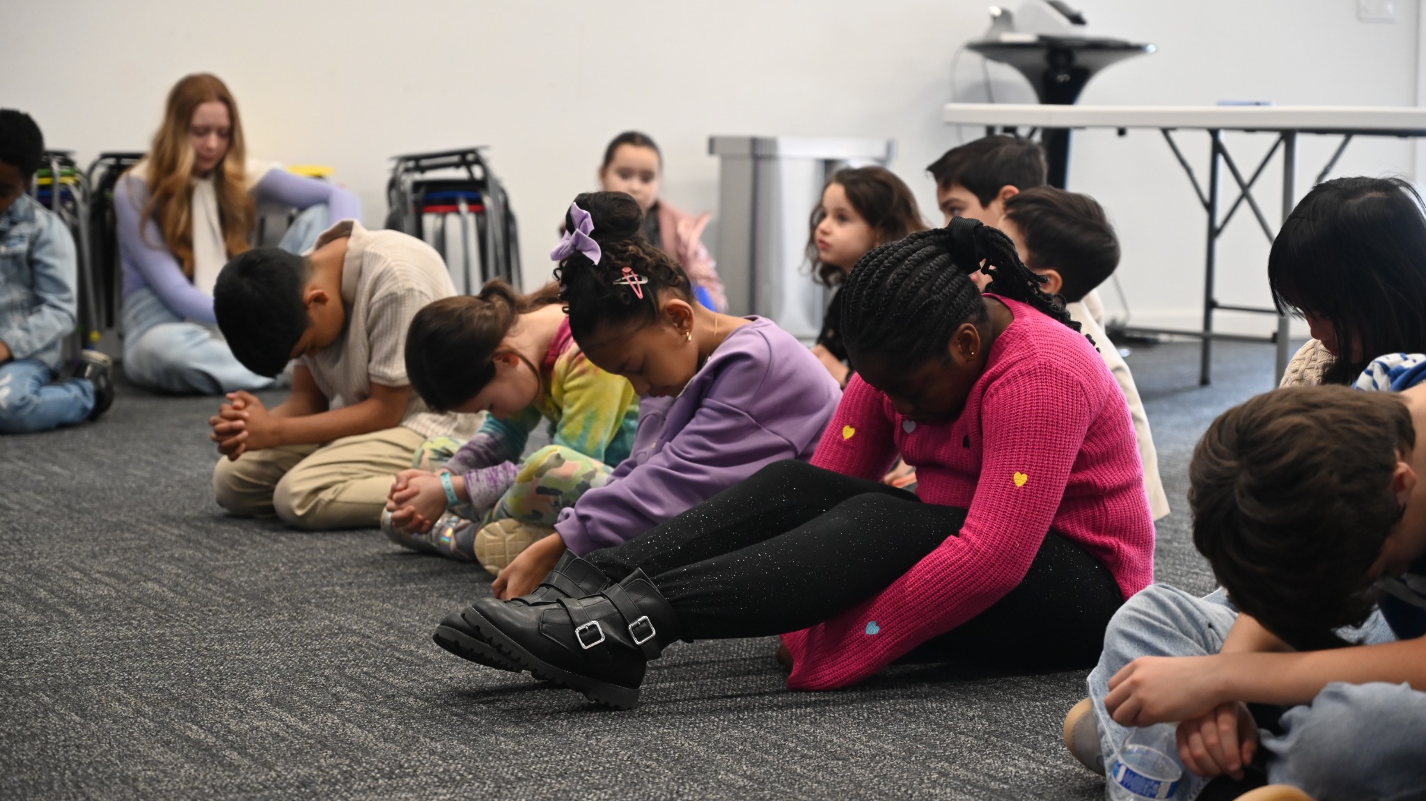 Children bowing their heads together in prayer