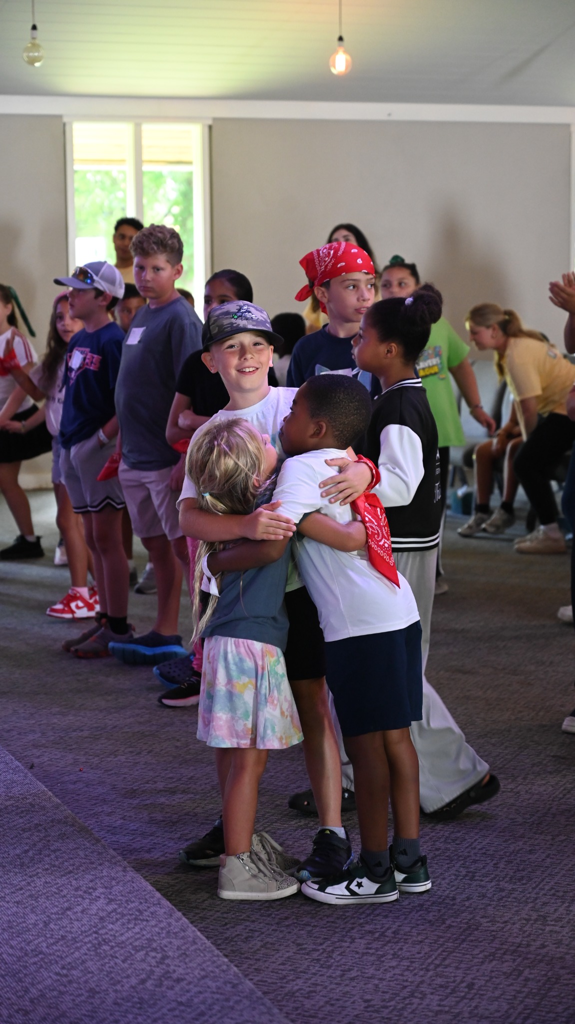 Children smiling and sharing a hug