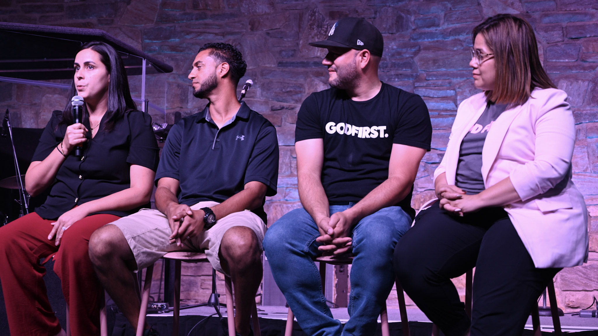 Four people sharing in a panel conversation at church