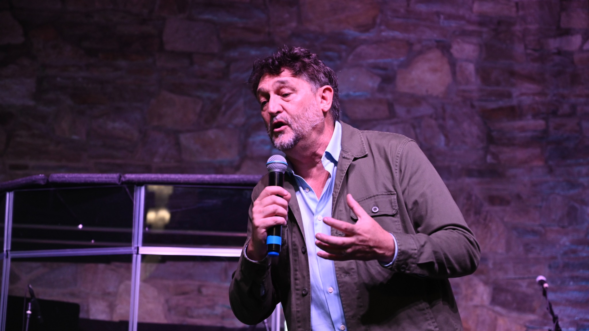 Kevin Mullins speaking with a microphone at Broad River Church
